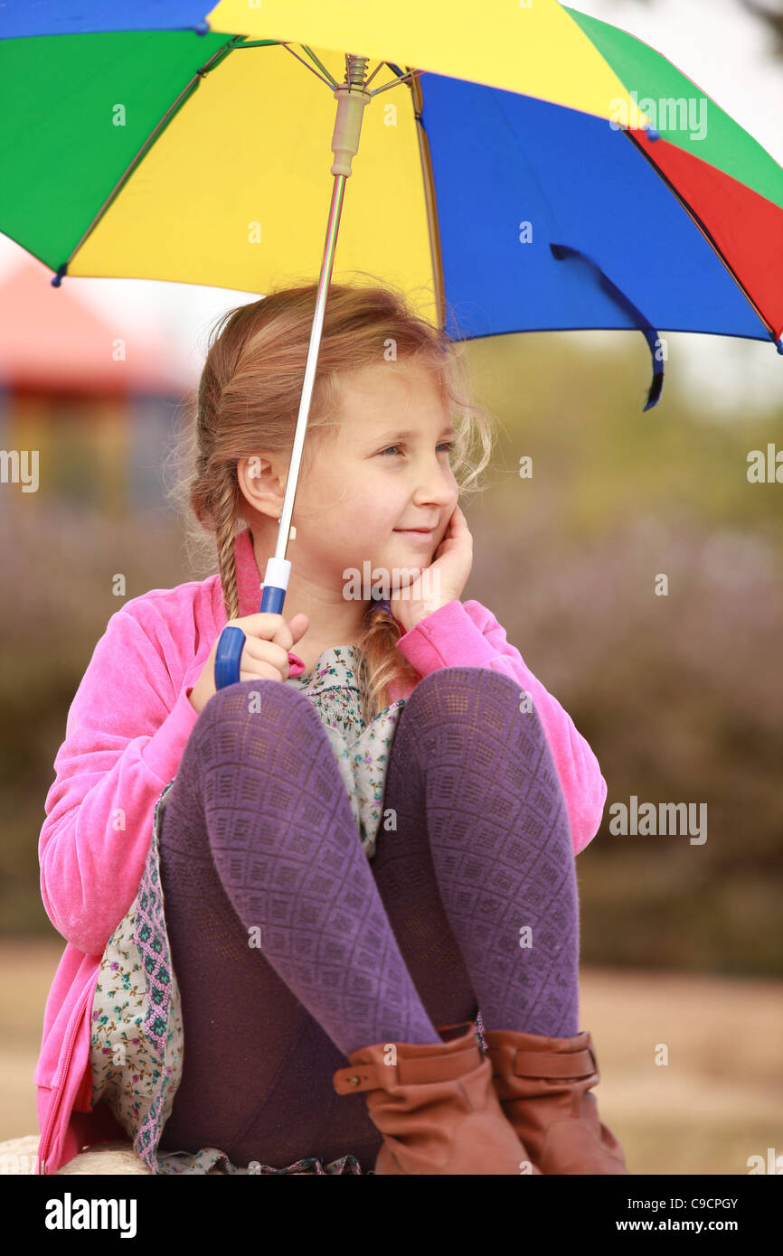 portrait of little girl with an color umbrella Stock Photo