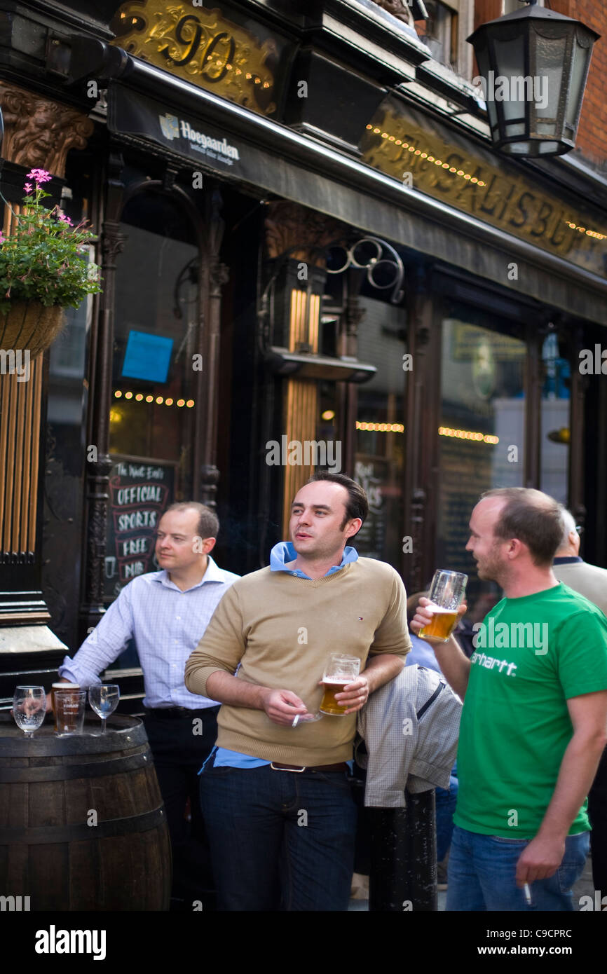 Young men drink beer outside the Salisbury, a Victorian era public