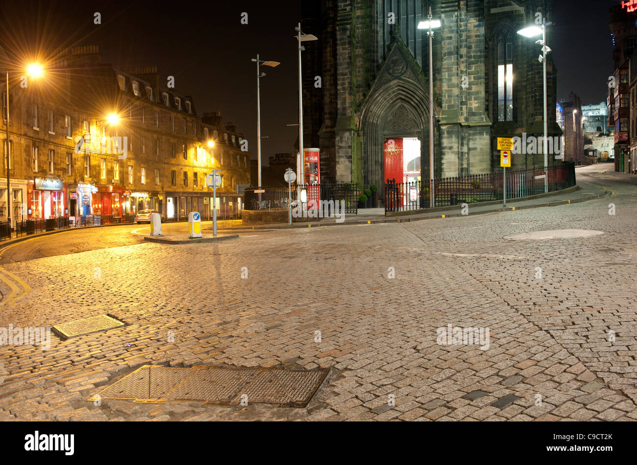 Edinburgh street scene at night looking towards Johnston Terrace and the Hub Café and Restaurant from The Royal Mile. Stock Photo