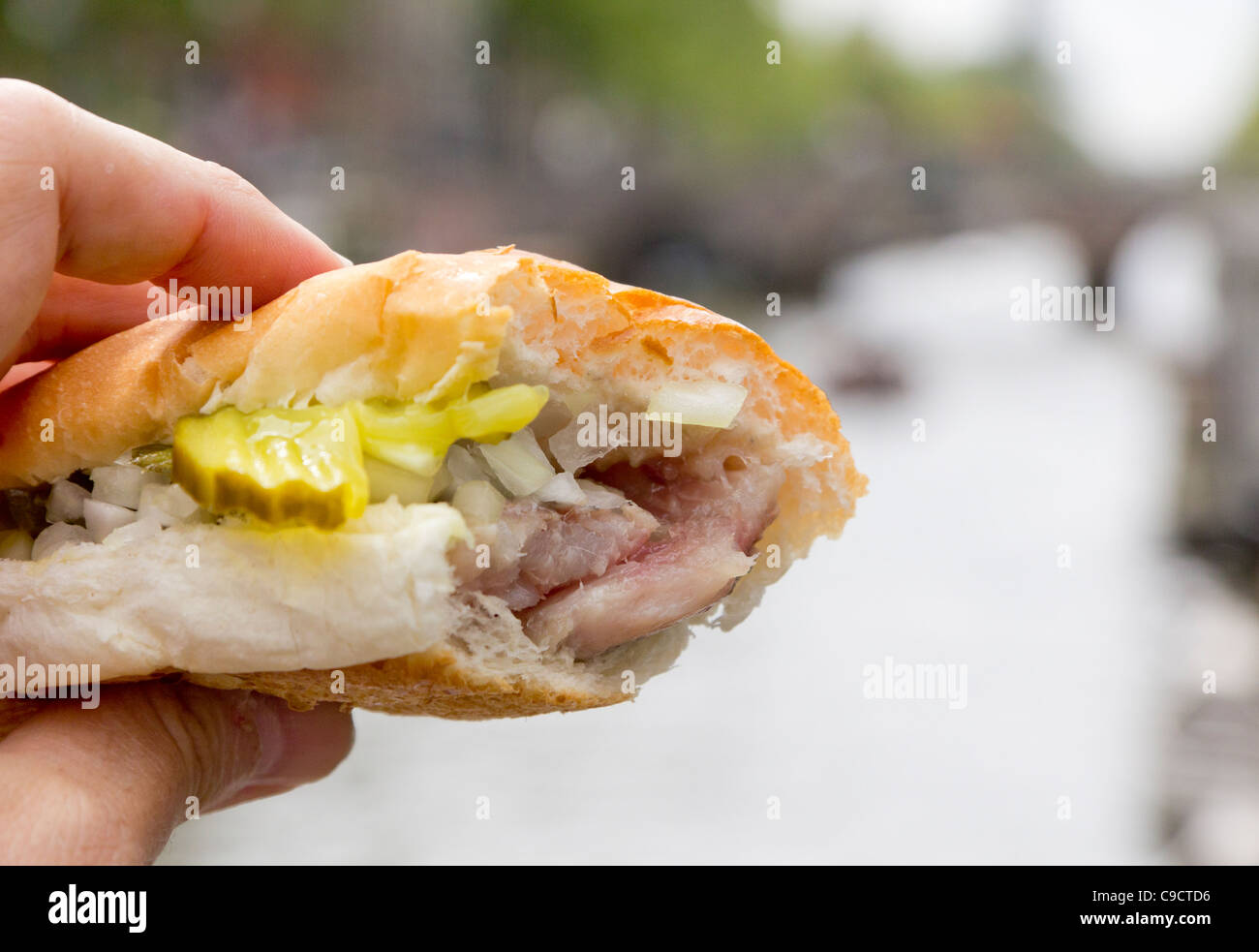 broodje herring - raw herring in a soft white roll with pickles Stock Photo