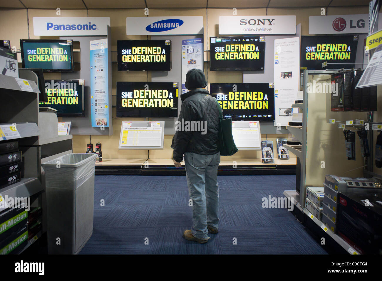 A shopper browses the flat screen television display at a Best Buy