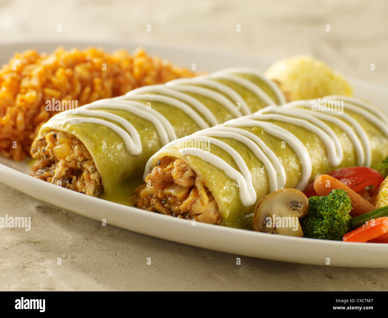 Chicken enchilada suiza with Spanish rice and vegetables Stock Photo