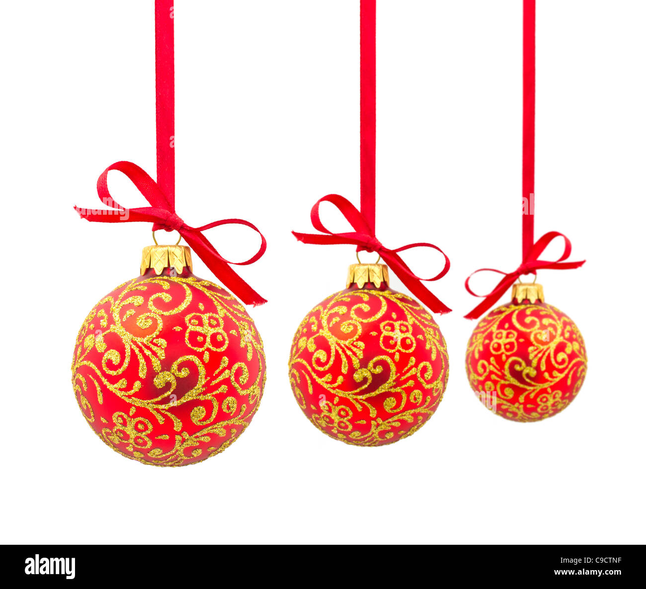 Three red Christmas balls in a row. Isolated on a white background