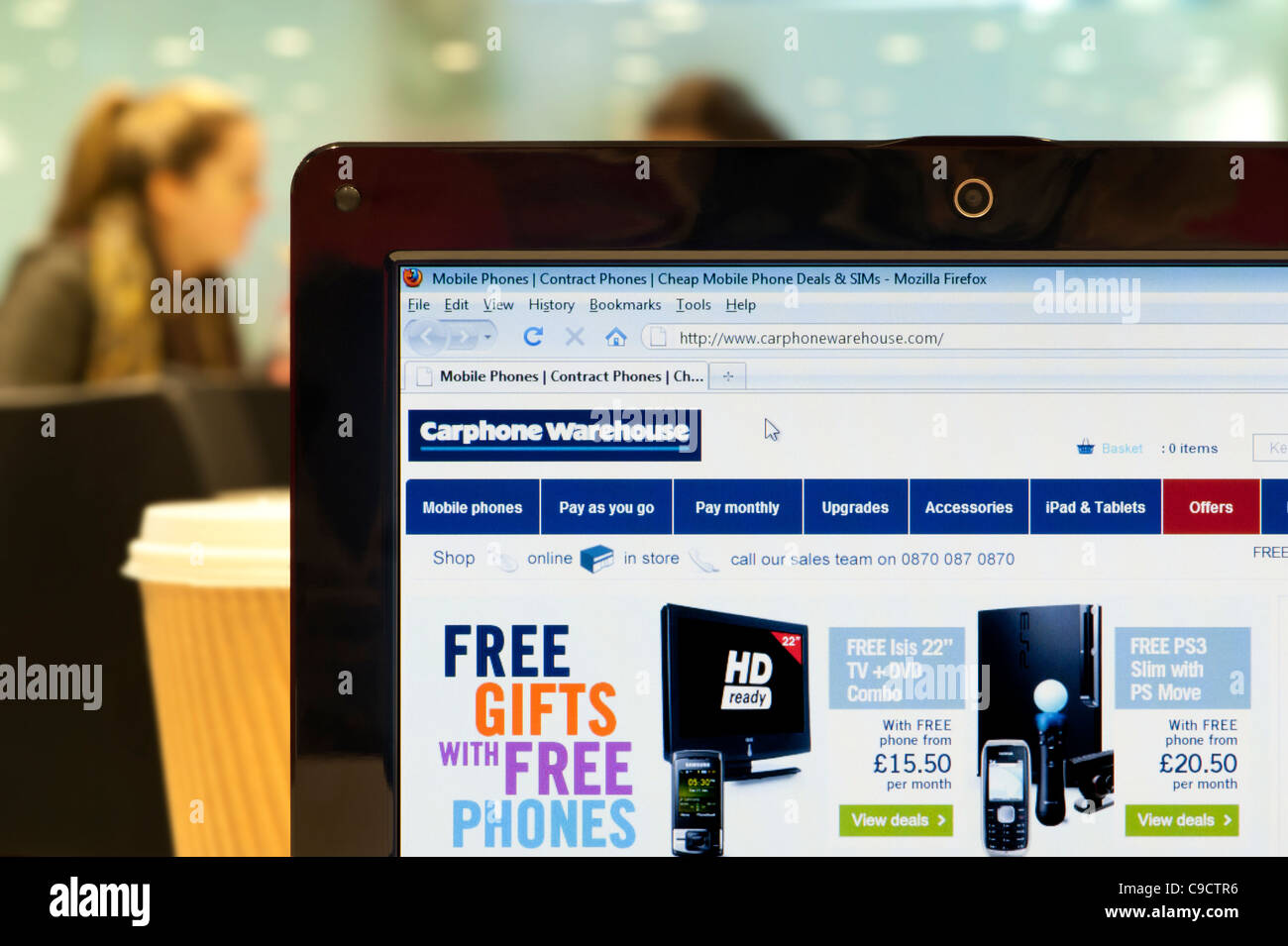 The Carphone Warehouse website shot in a coffee shop environment (Editorial use only: print, TV, e-book and editorial website). Stock Photo