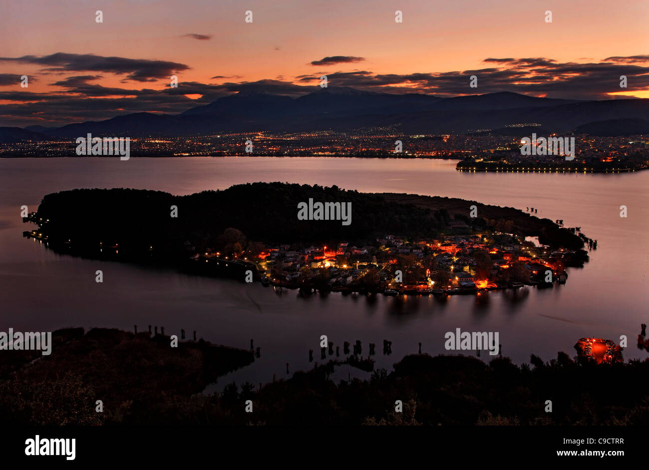 Panoramic sunset  view of Ioannina town, its lake ("Pamvotis" or "Pamvotida"), the islet of the lake and its village. Greece Stock Photo