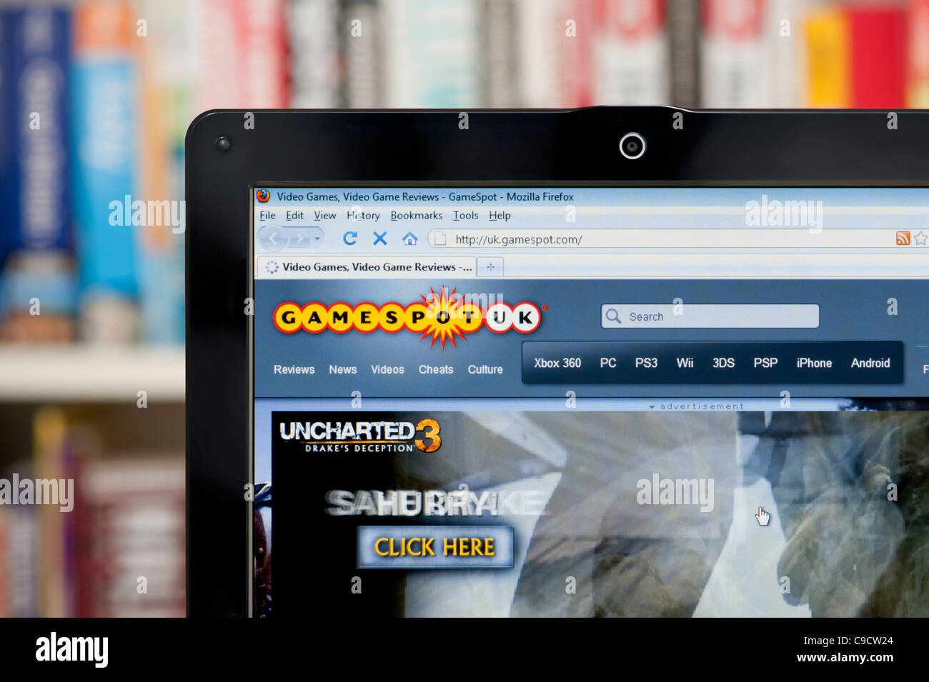 The Gamespot website shot against a bookcase background (Editorial use only: print, TV, e-book and editorial website). Stock Photo
