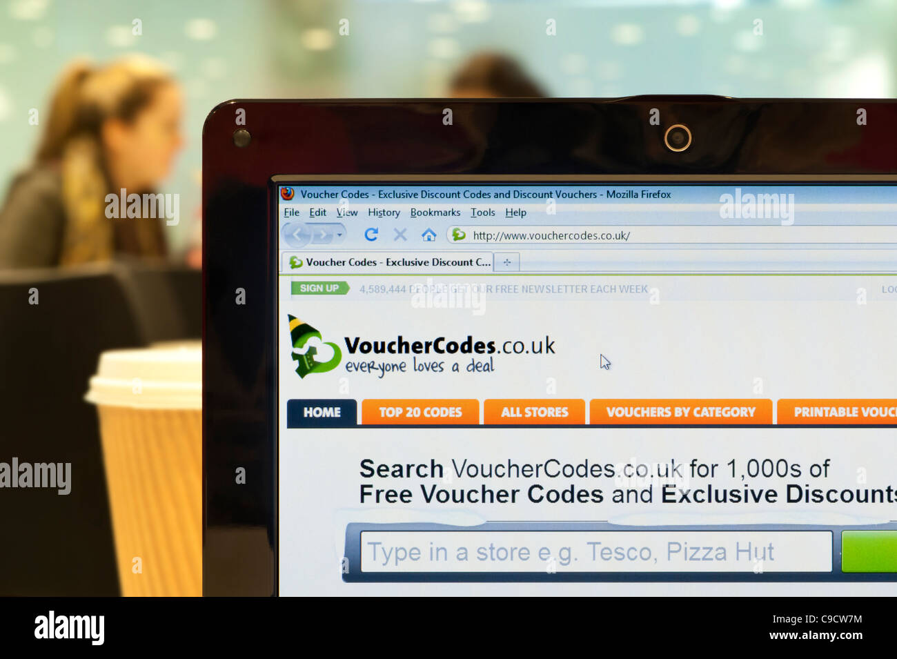 The Voucher Codes website shot in a coffee shop environment (Editorial use only: print, TV, e-book and editorial website). Stock Photo