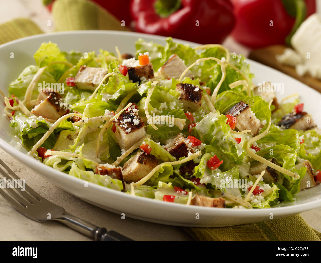Grilled chicken caesar salad in a white bowl Stock Photo
