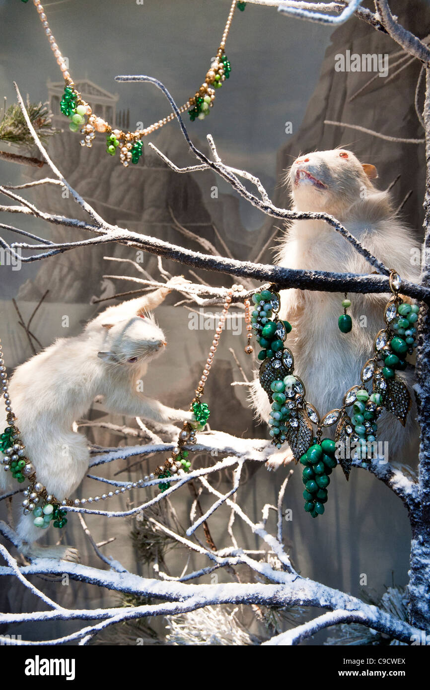 pair of adorable albino hamsters play on snowy boughs draped with retro jewelery in Bergdorf Goodman 2011 Christmas window NYC Stock Photo
