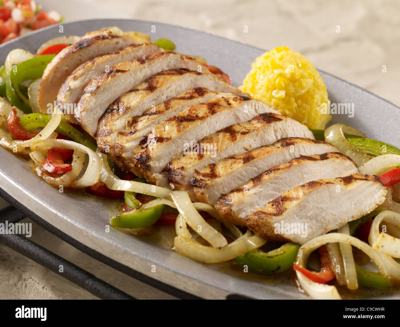 Grilled chicken fajitas over vegetables Stock Photo