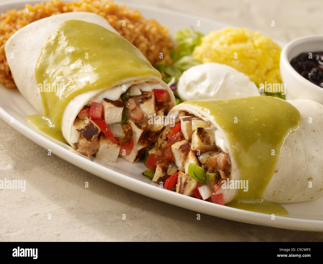 Chicken Fajita burrito topped with green salsa and sour cream and Stock