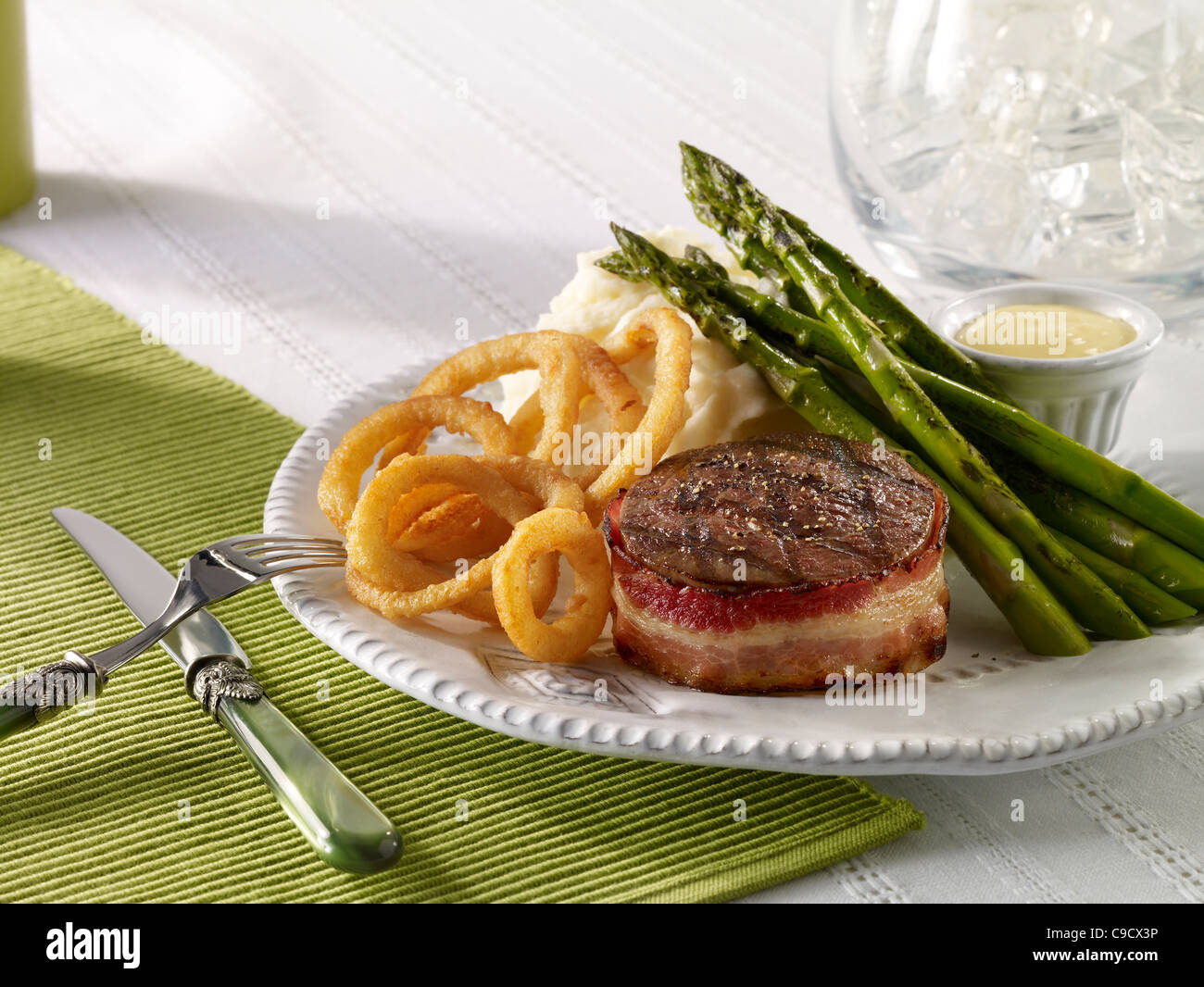 Beef tenderloin served with mash potato, asparagus and onion rings Stock Photo