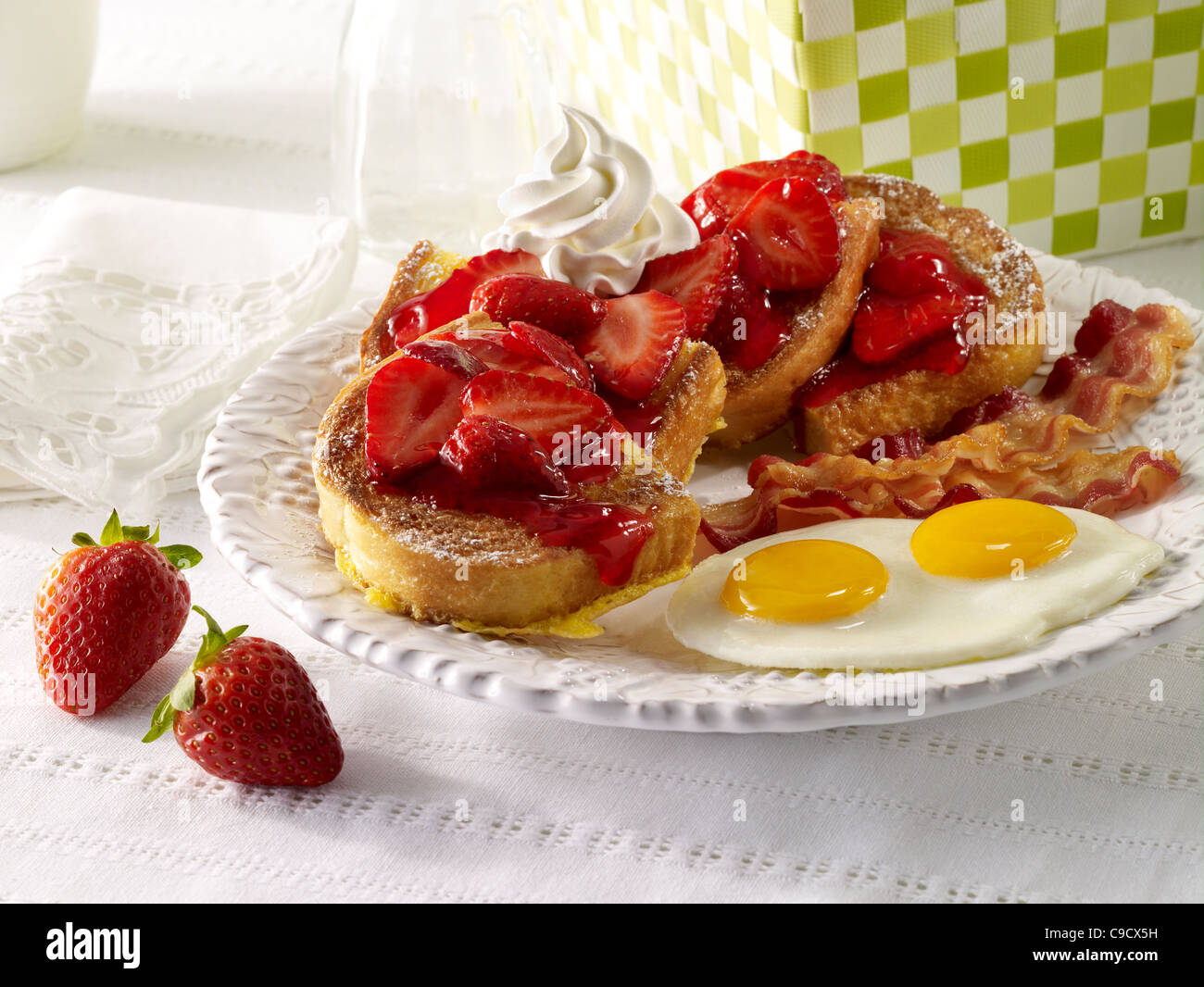 Strawberry French Toast with bacon and eggs Stock Photo