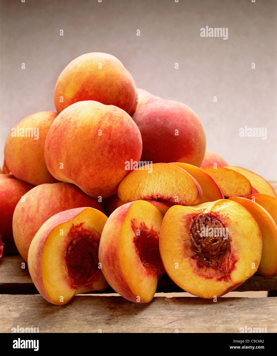Yellow freestone peaches whole and halved showing stone Stock Photo Alamy