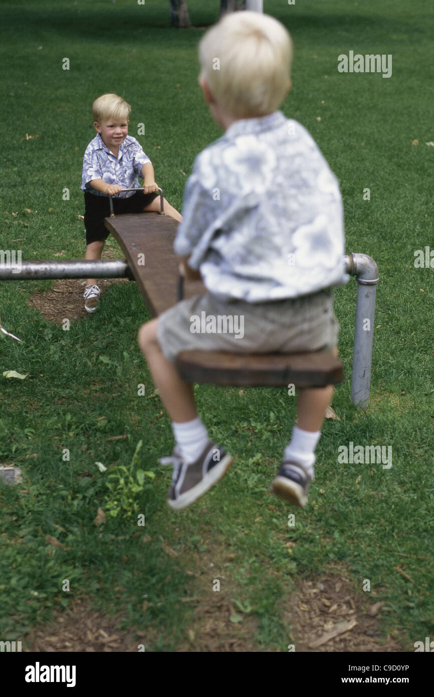 Two Children Playing On A Seesaw Stock Photo Alamy