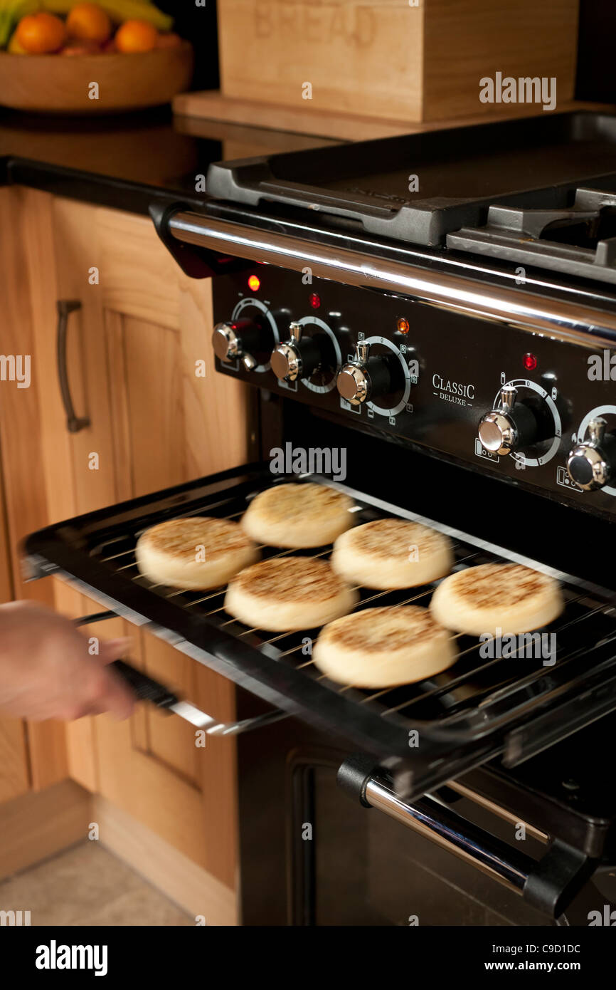 Crumpets are slid out of a toaster. A slow shutter speed captures the