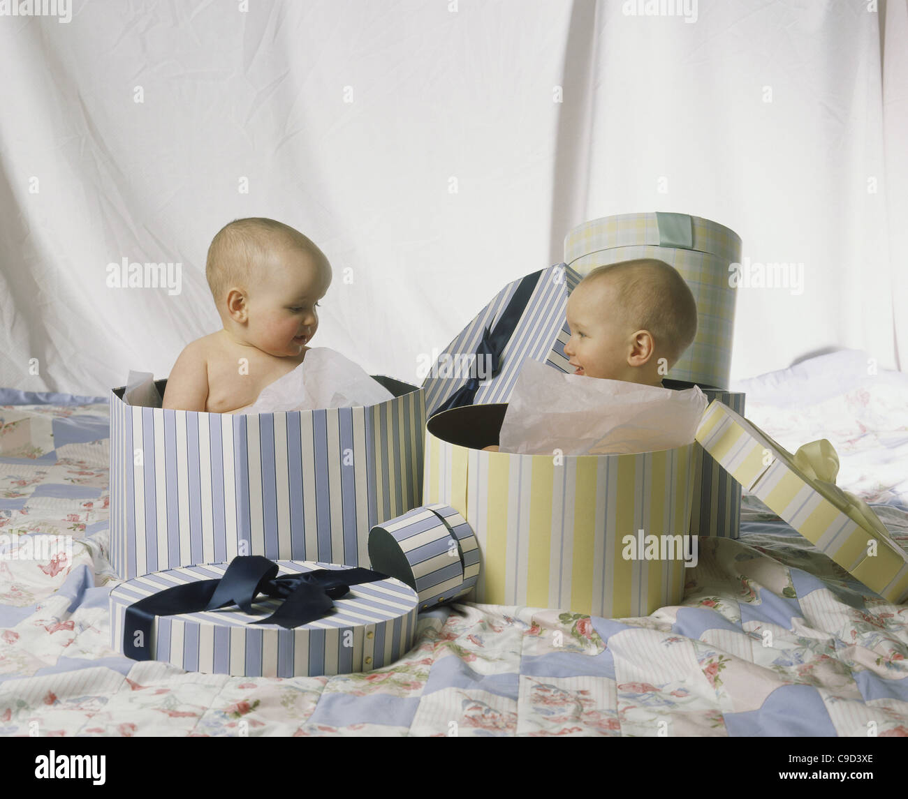 Male twins in gift boxes Stock Photo - Alamy