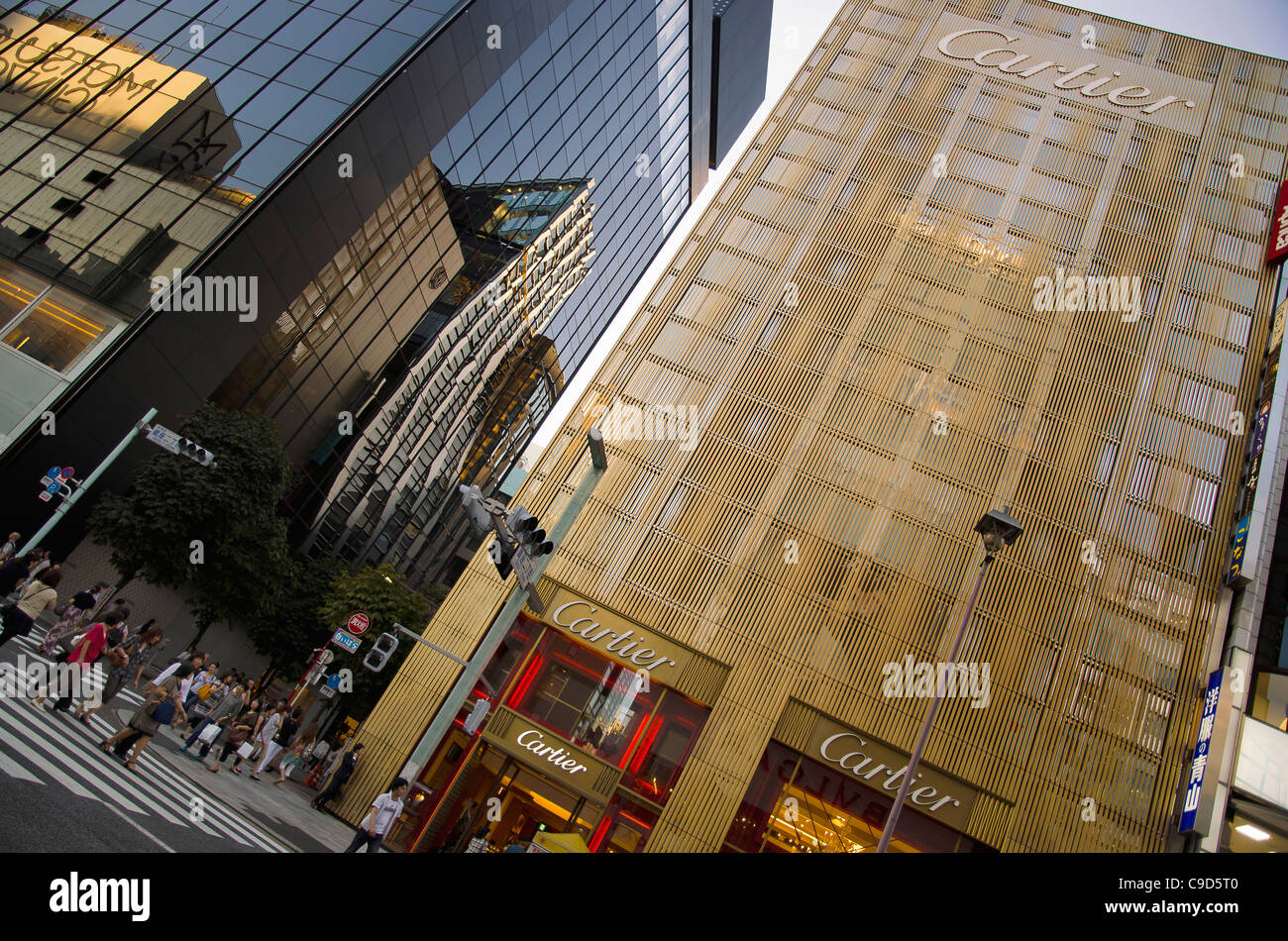 Japan, Tokyo, Ginza, Golden facade of the Cartier Building with the Chanel Building on left and De Beers curved facade reflected Stock Photo