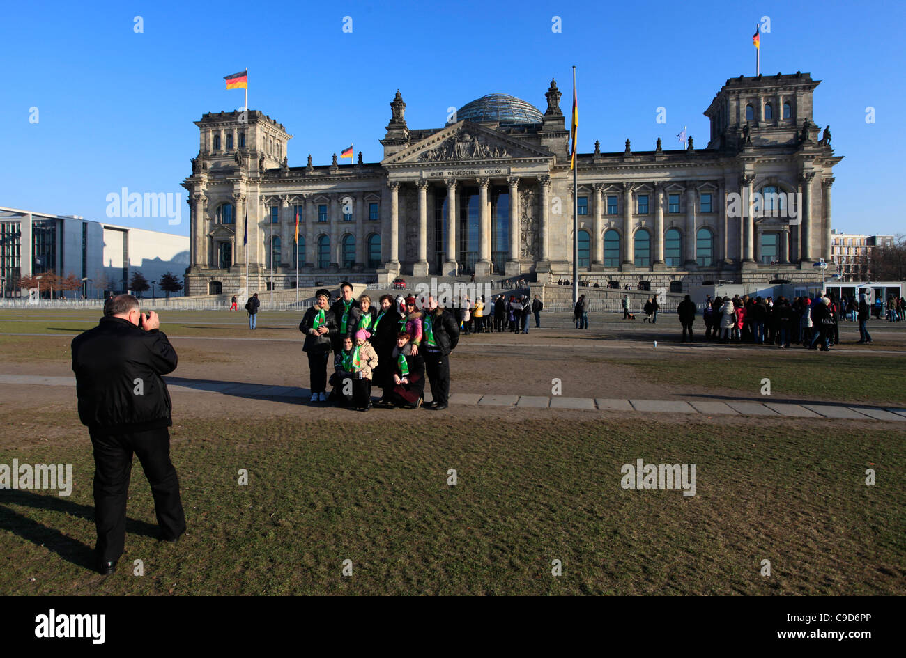 A group of Russian tourists taking a photograph in front of the Reichstag building seat of the Bundestag in Berlin Germany Stock Photo