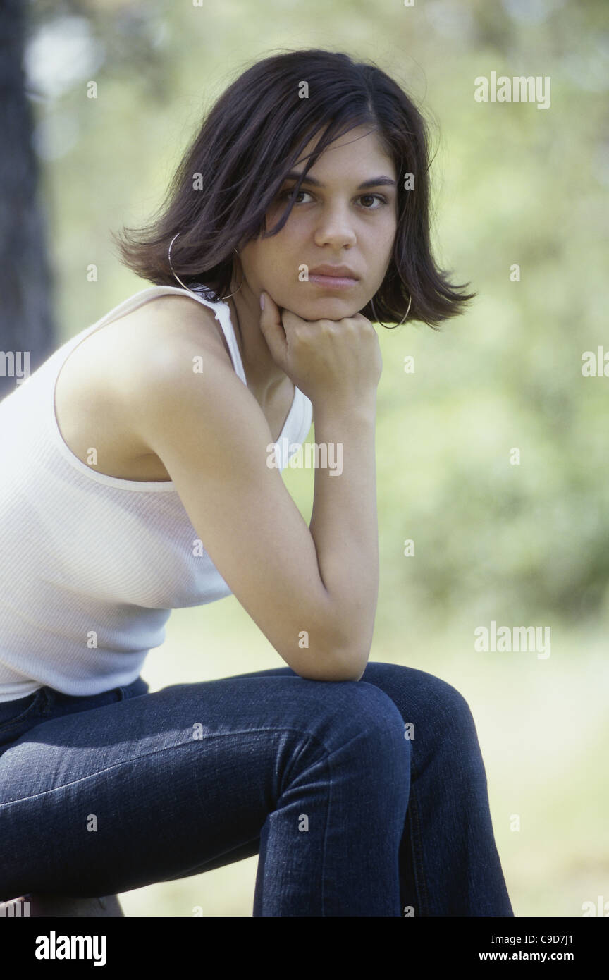 Portrait of a young woman sitting Stock Photo - Alamy