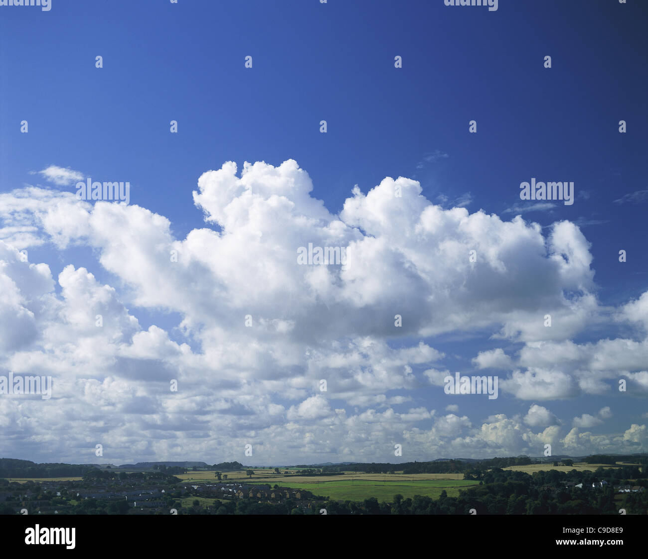 Blue sky and fluffy clouds over a landscape Stock Photo - Alamy