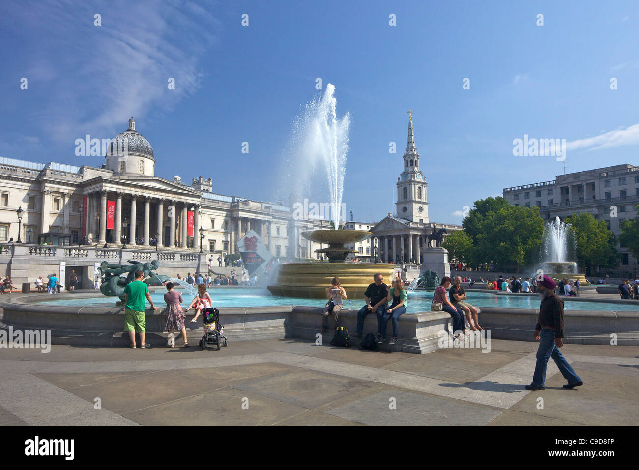 Fountains, National Gallery and St Martins-in-the-Fields church in Trafalgar Square, summer sunshine, London,  England, UK, Unit Stock Photo