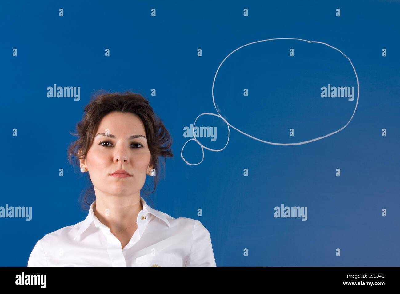 Image of young woman thinking on blue board Stock Photo