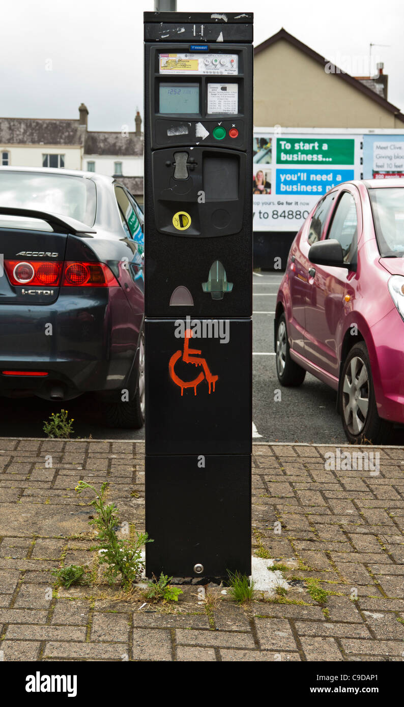Disabled sign painted on car park ticket machine Stock Photo - Alamy