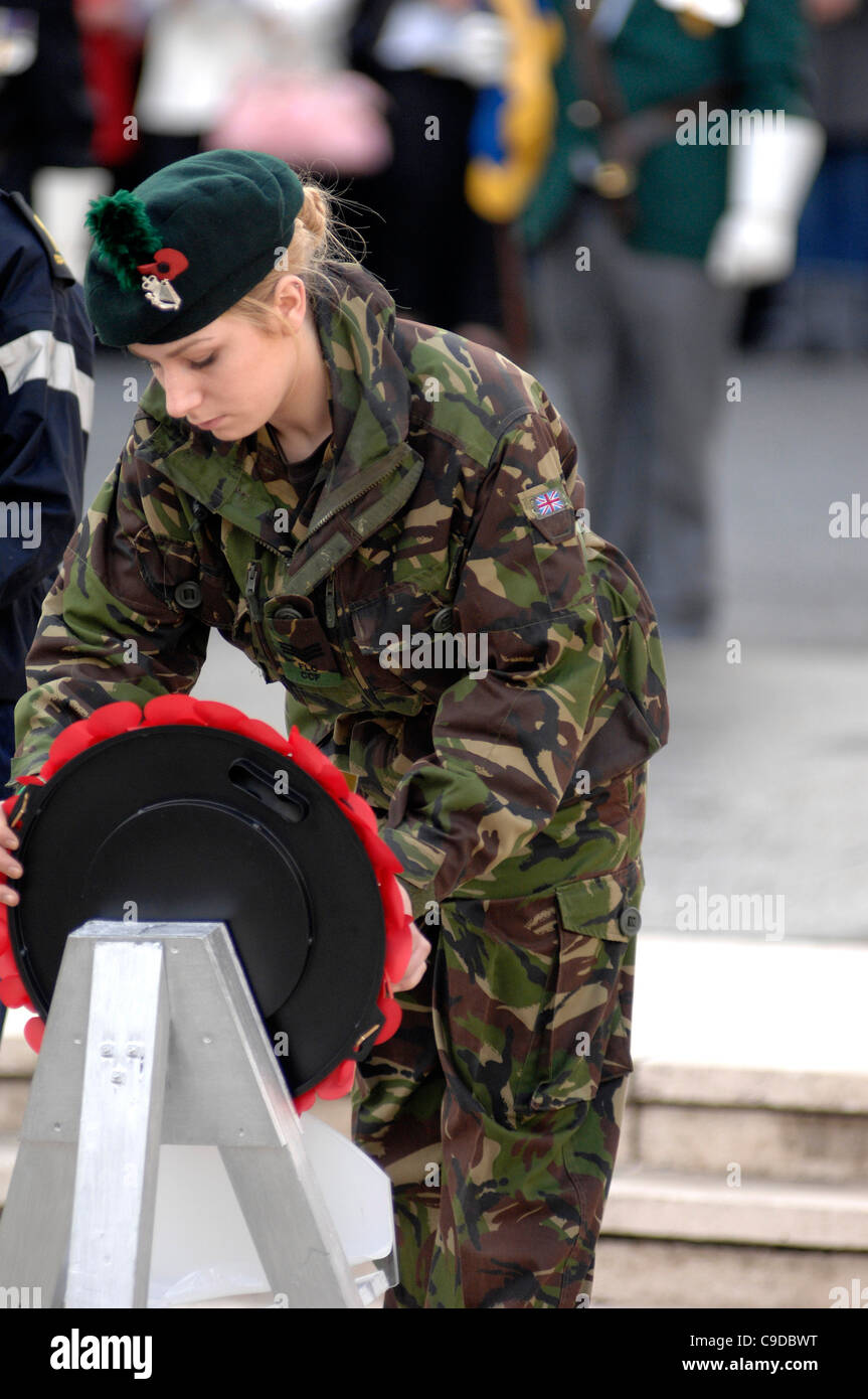 A female NCO from the Royal Irish Regiment, lays a wreath at the War Memorial, Londonderry on Remembrance Sunday. Stock Photo