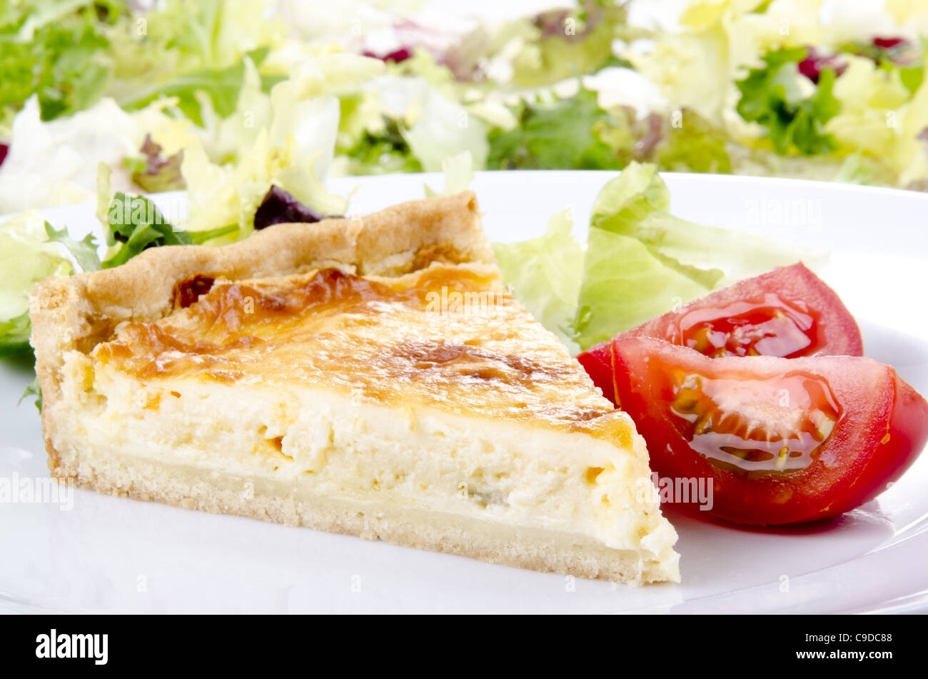 cheese and onion quiche with tomato Stock Photo - Alamy