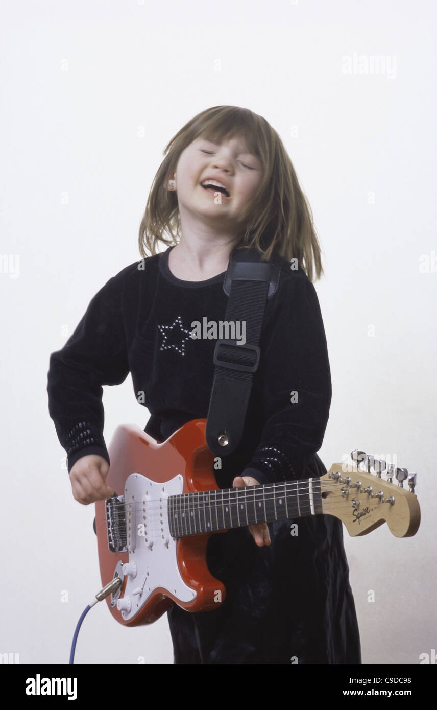 Girl playing an electric guitar Stock Photo - Alamy