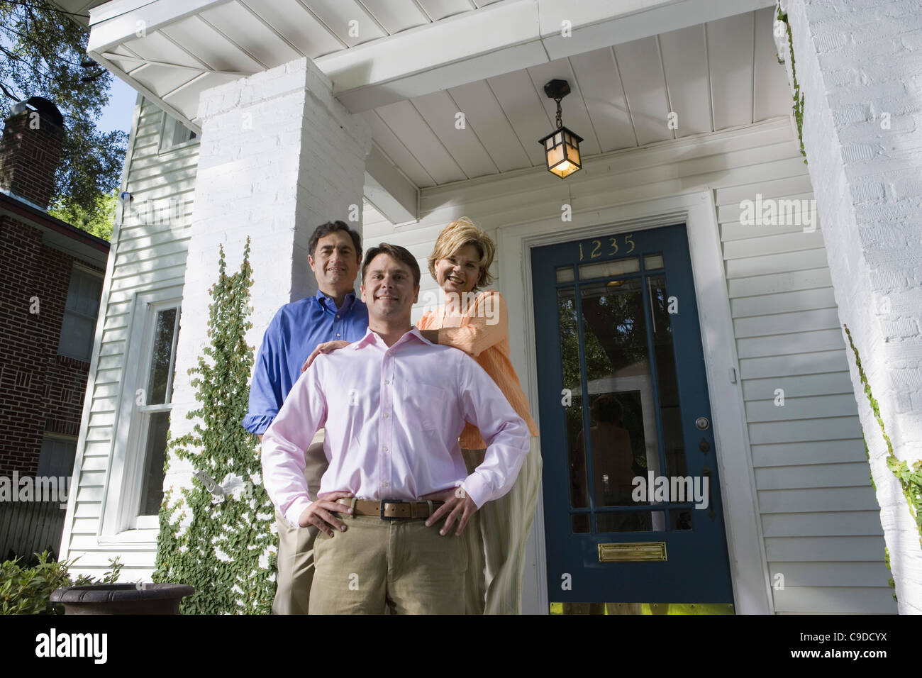 Portrait of a family standing outside a house Stock Photo - Alamy