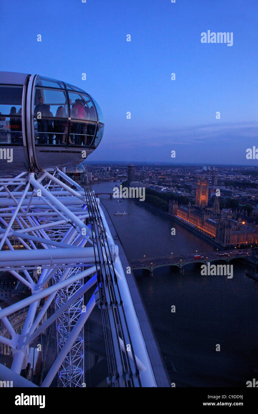 View of passenger pod capsule, Houses of Parliament, Big Ben and the River Thames from the London Eye at dusk,  London,  England Stock Photo