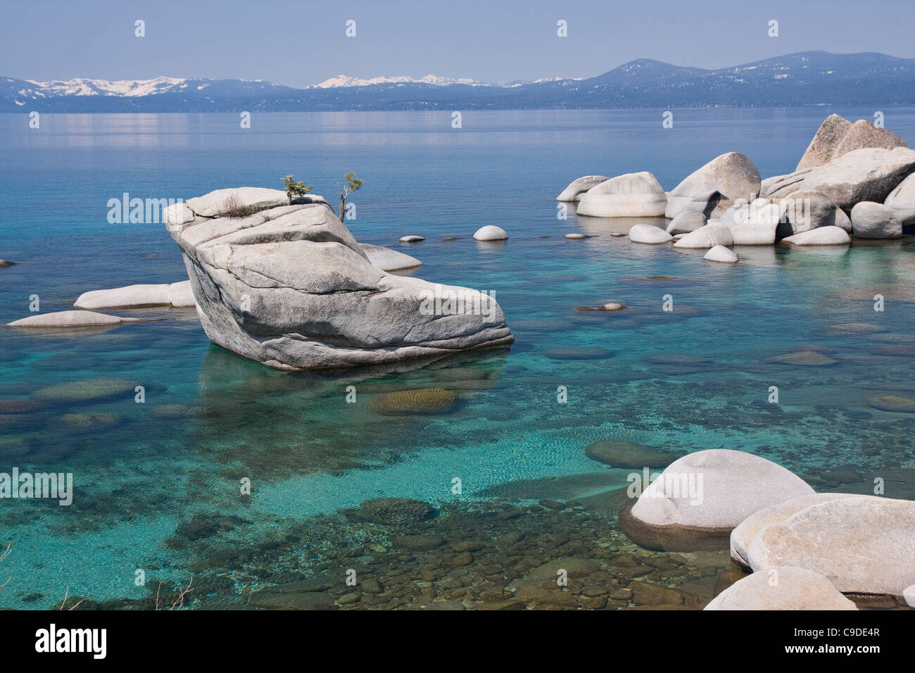 Bonsai rocks in a lake with mountains in the background, East Shore, Lake Tahoe, Nevada, USA Stock Photo
