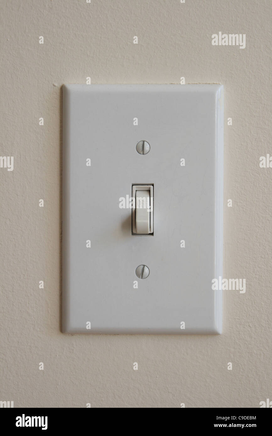 wall light switch flipped down to the off position Stock Photo