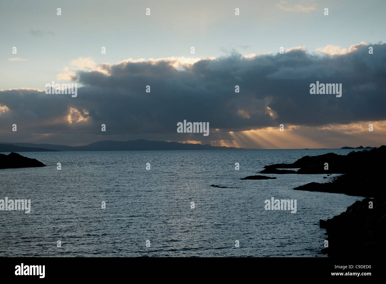 Loch nan Uamh on the west coast of Scotland, looking to the Sound of Arisaig and Rum and Eigg at dusk. Stock Photo