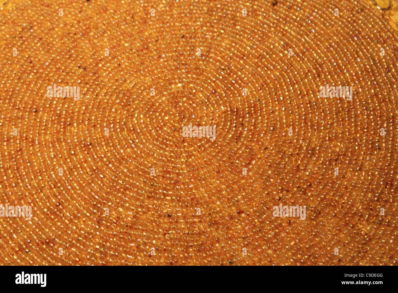 yellow spiral beadwork background with a shallow depth of field Stock Photo