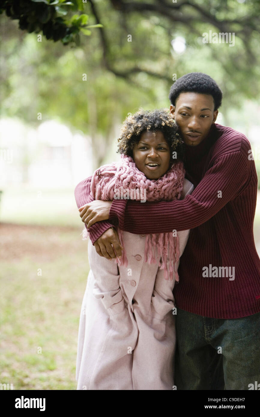 Young man embracing a young woman Stock Photo - Alamy