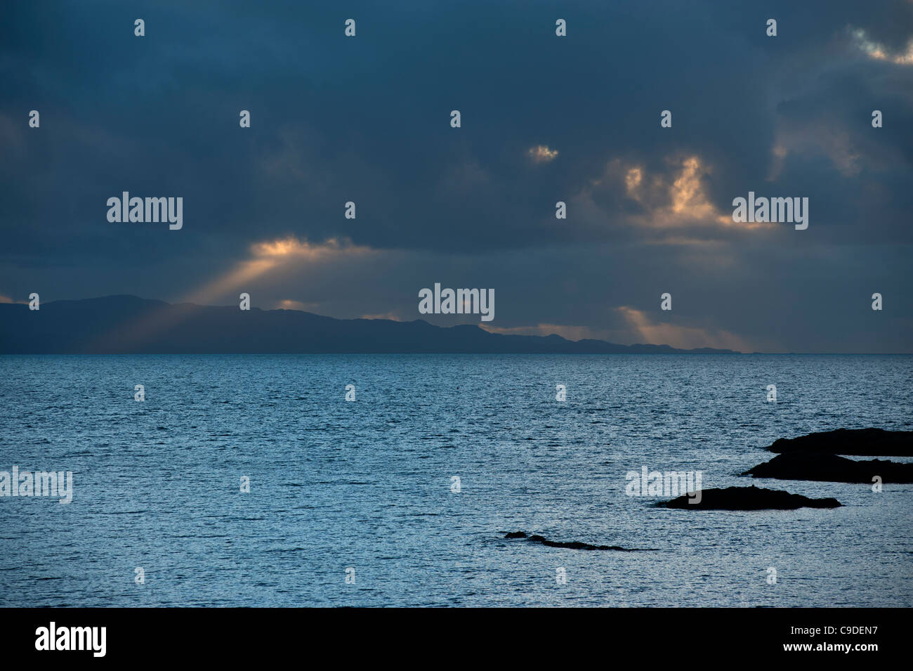 Loch nan Uamh on the west coast of Scotland, looking to the Sound of Arisaig and Rum and Eigg at dusk. Stock Photo