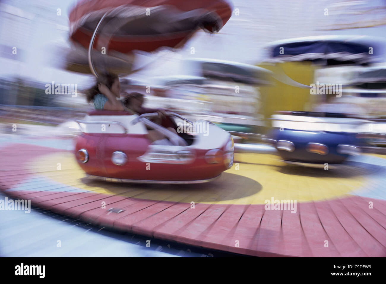 People on an amusement park ride Stock Photo - Alamy