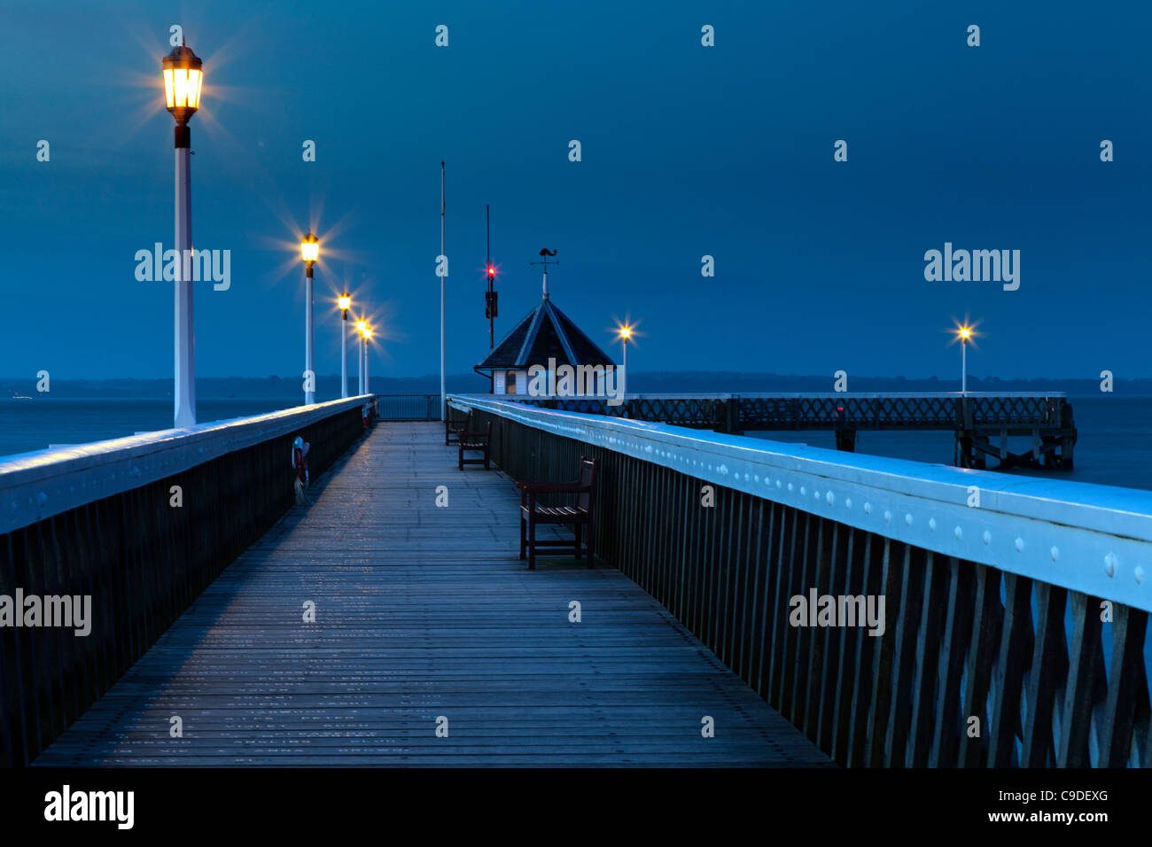 Empty Yarmouth wooden Pier Isle of Wight at dusk Stock Photo