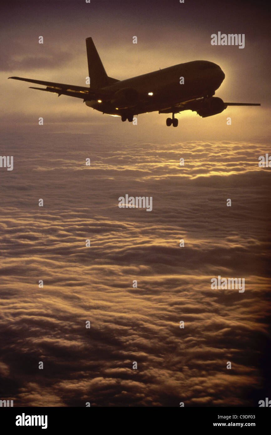 Silhouette of an airplane flying in the sky Stock Photo - Alamy