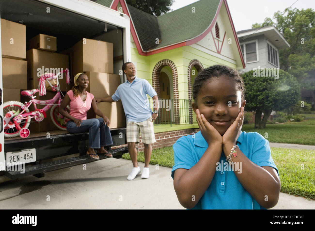 Portrait of a family standing outside a house by moving truck Stock ...