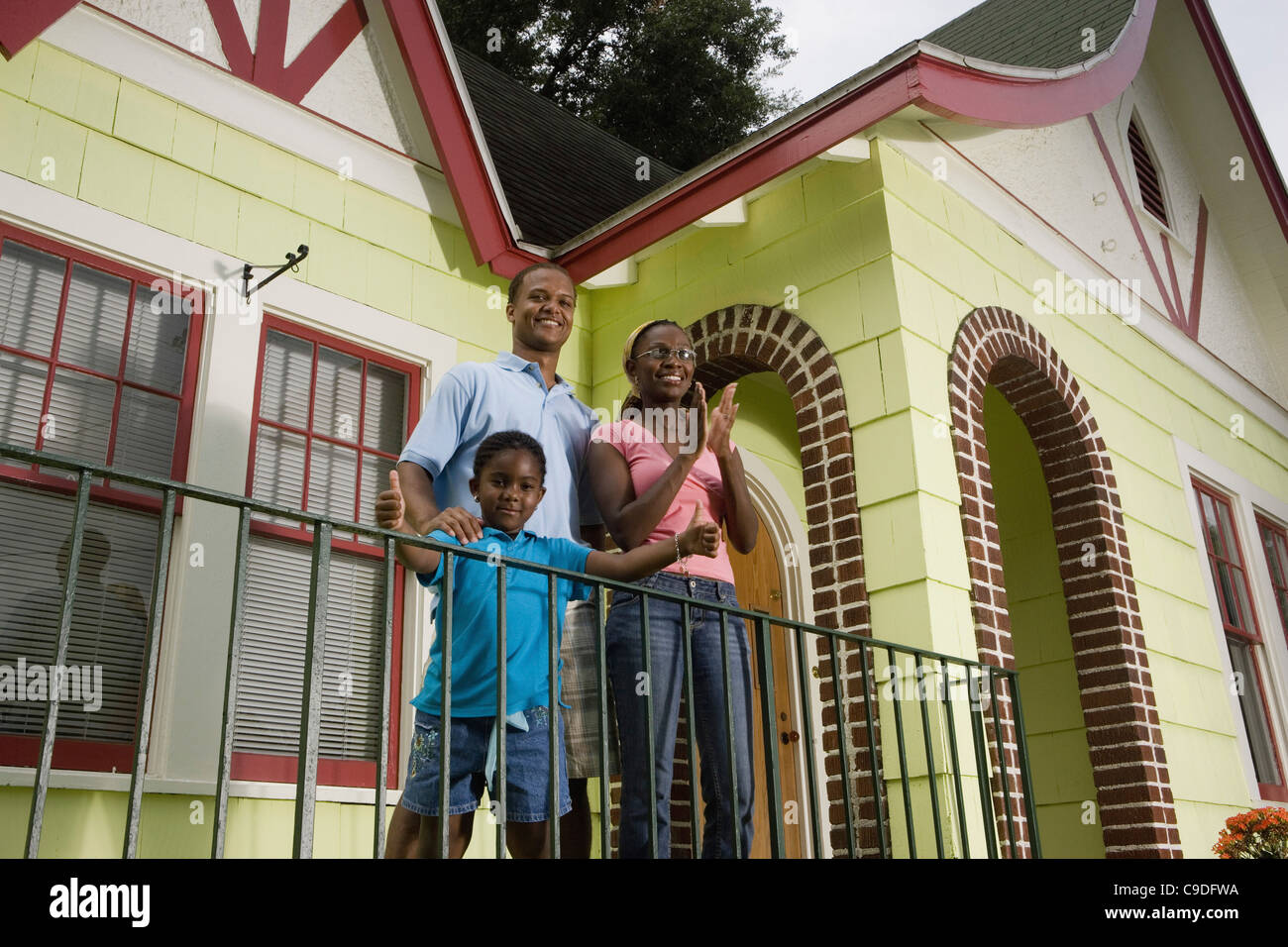 Family standing outside house Stock Photo Alamy