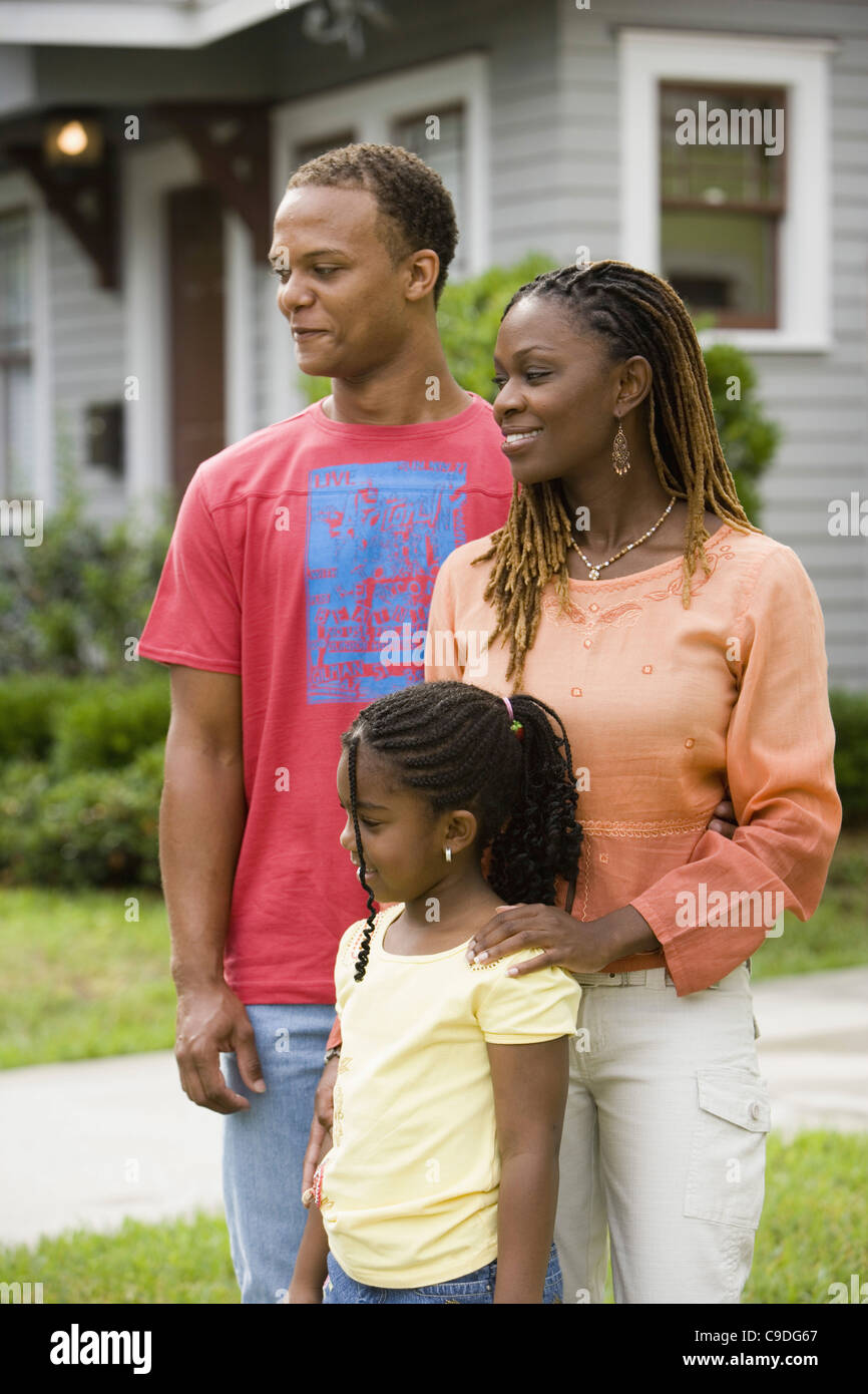 Family standing outside house Stock Photo - Alamy