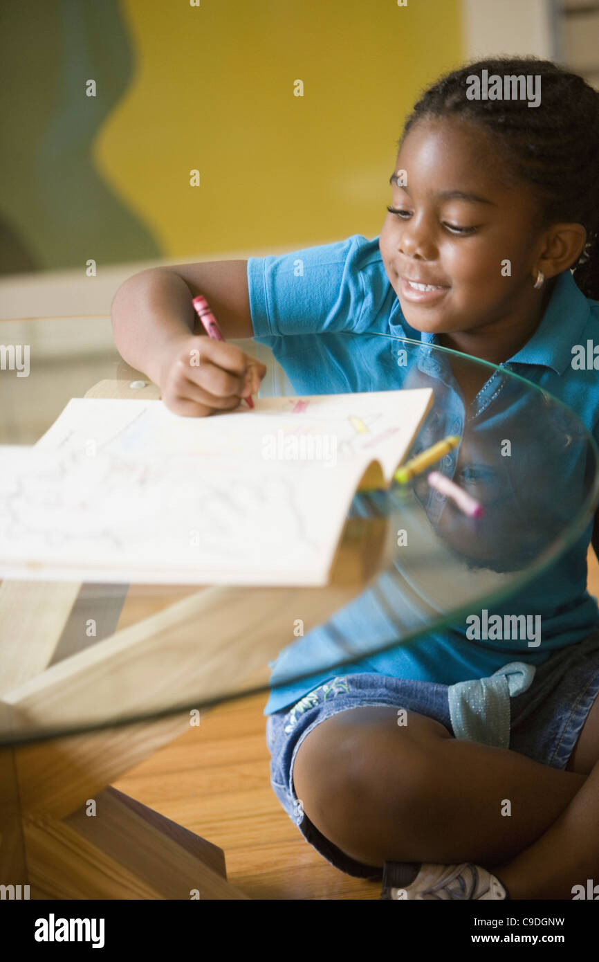 Girl coloring a book Stock Photo - Alamy