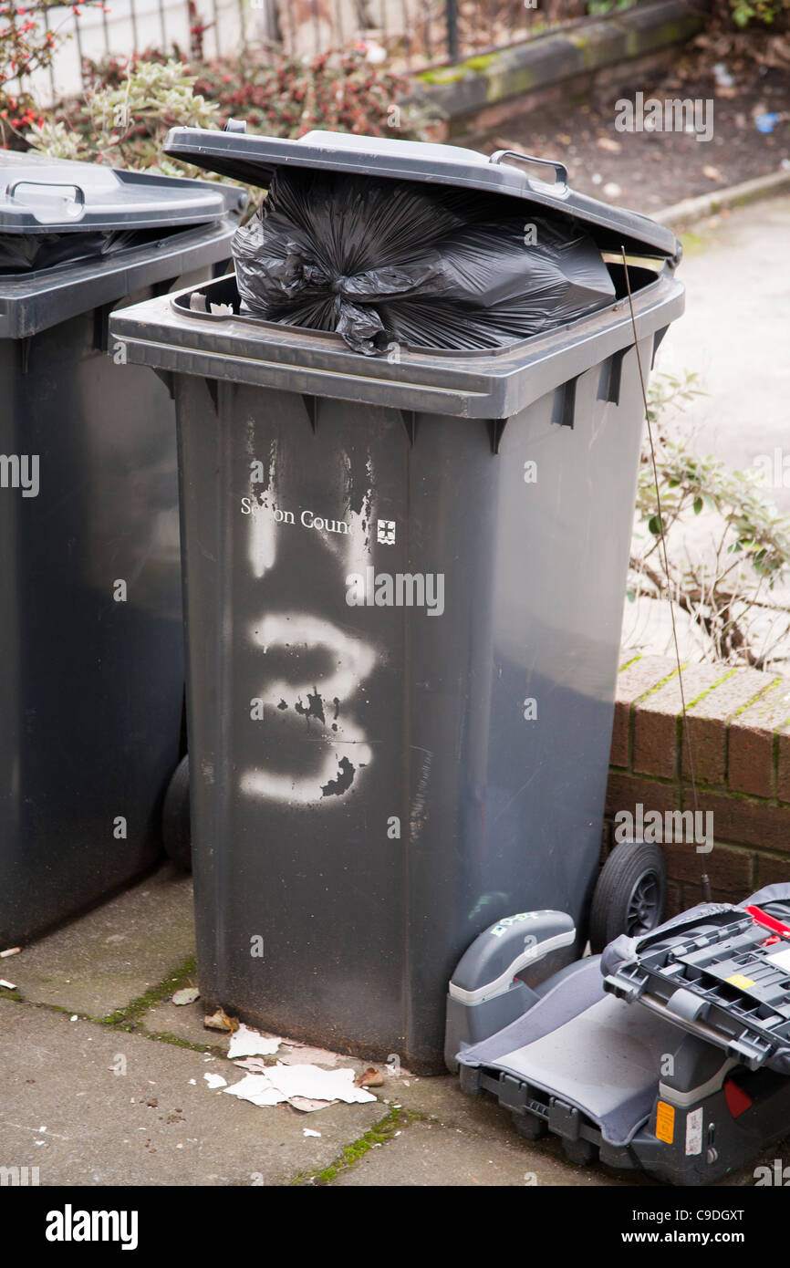 Bins overflowing with rubbish. Filled with non recycled waste, these