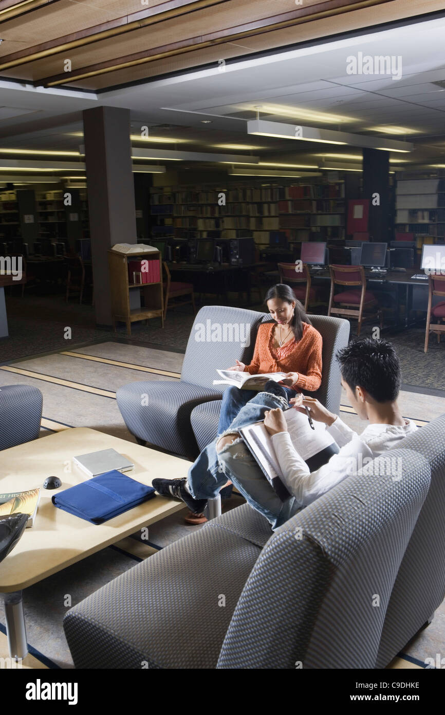 Students in library sitting on chairs studying Stock Photo Alamy