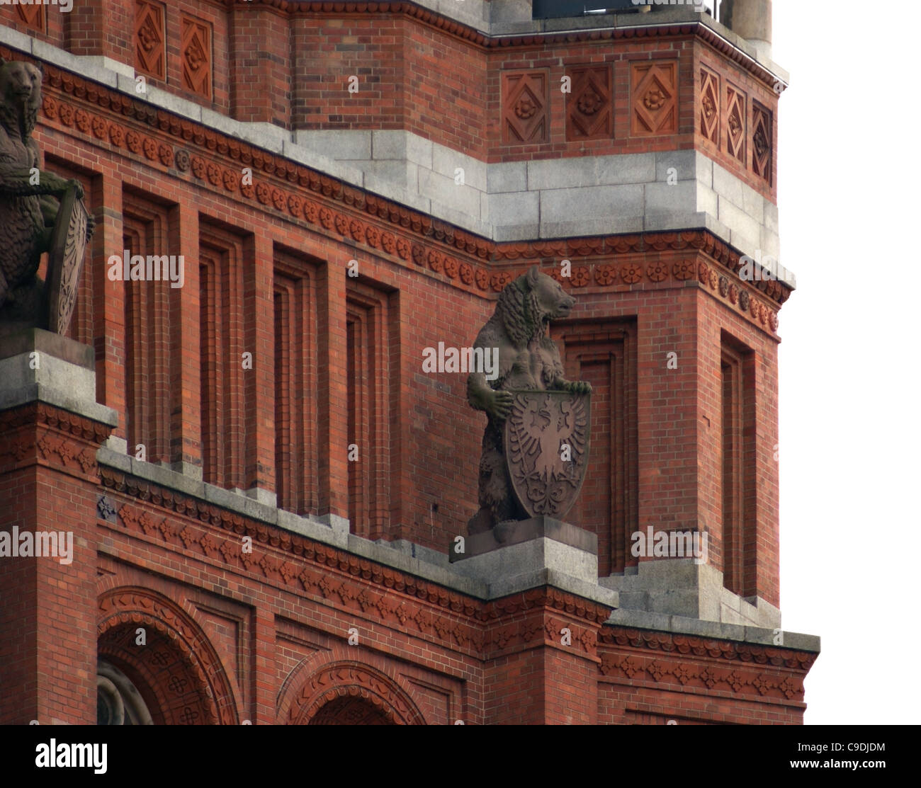 detail of the Red Town Hall in Berlin (Germany) with red brick facade and stone figures Stock Photo