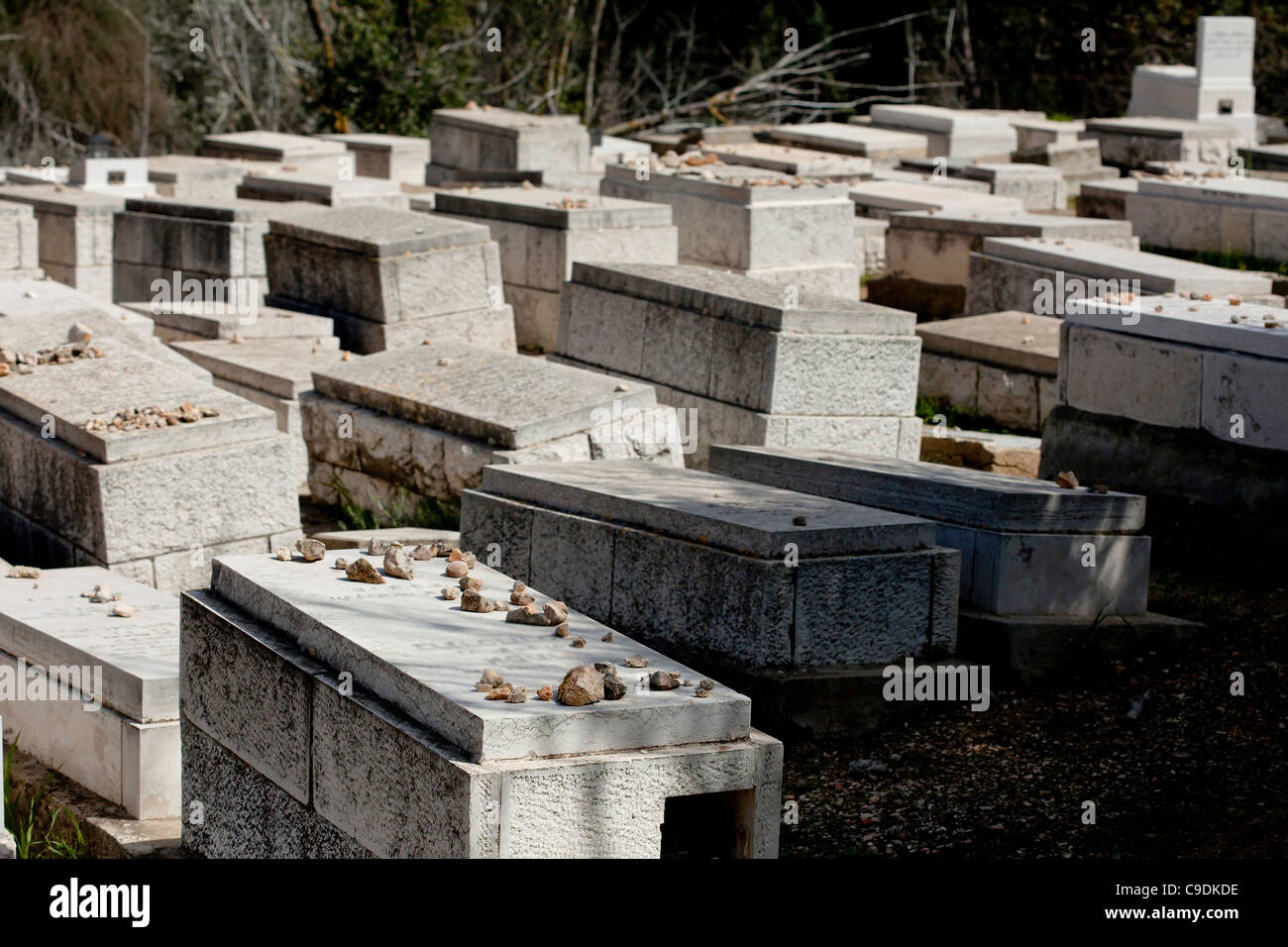graves with Hebrew inscription in the old Jewish cemetery on mount Olives, Jerusalem over looking the old city Stock Photo